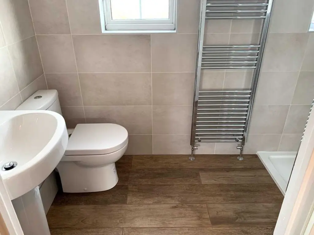 Tiles bathroom with chrome towel rail