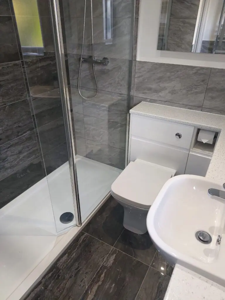 Shower room with Lakes walk-in shower panel, Atlanta gloss white grip furniture. Tiles from Minoli Tiles Oxford