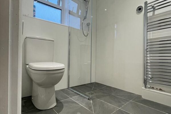 Wetroom shower with glass panel